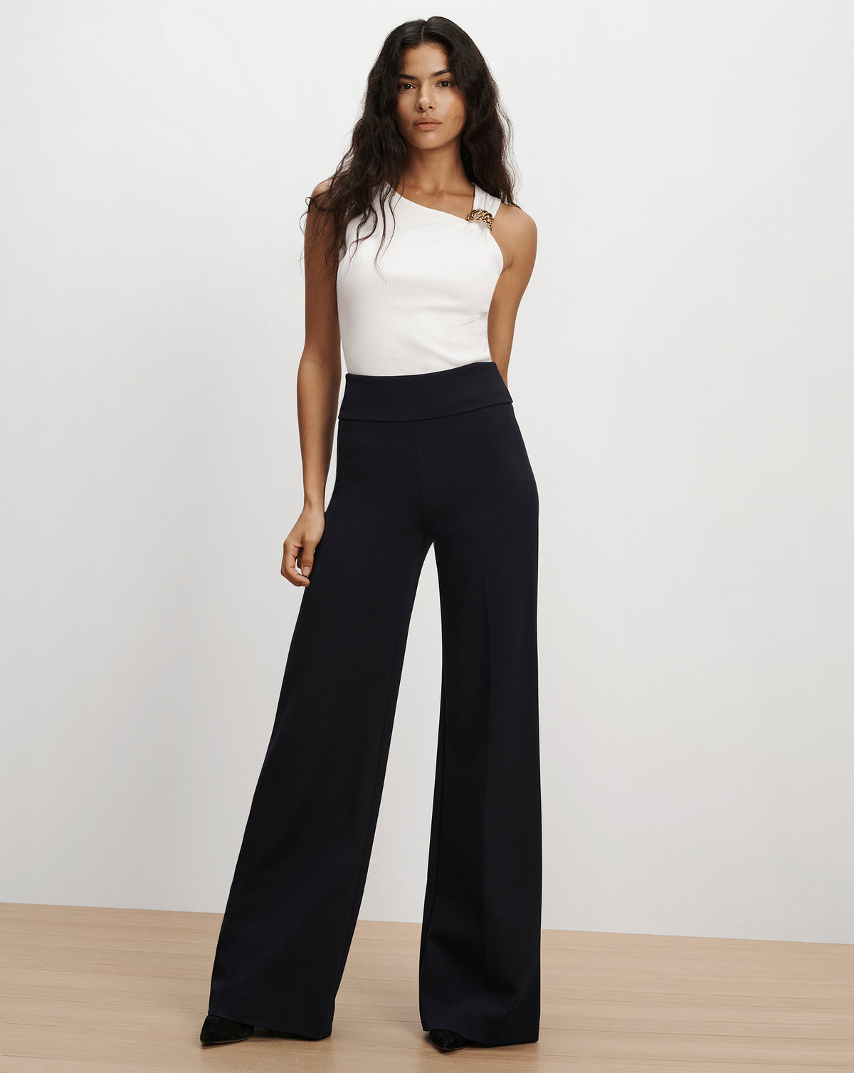 Veronica Beard Black wide-leg trousers and white top.