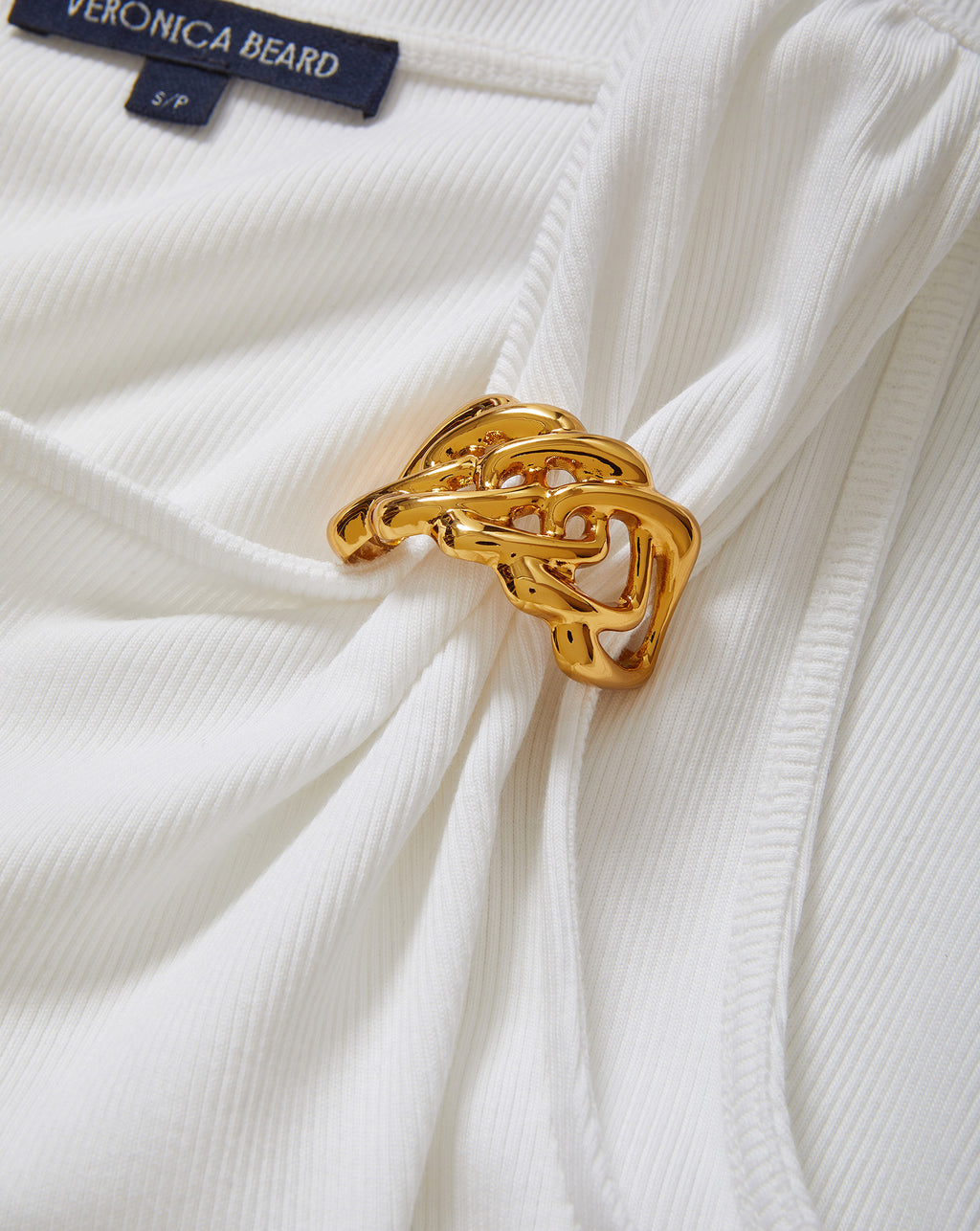 Veronica Beard White ribbed top with gold chain accent.