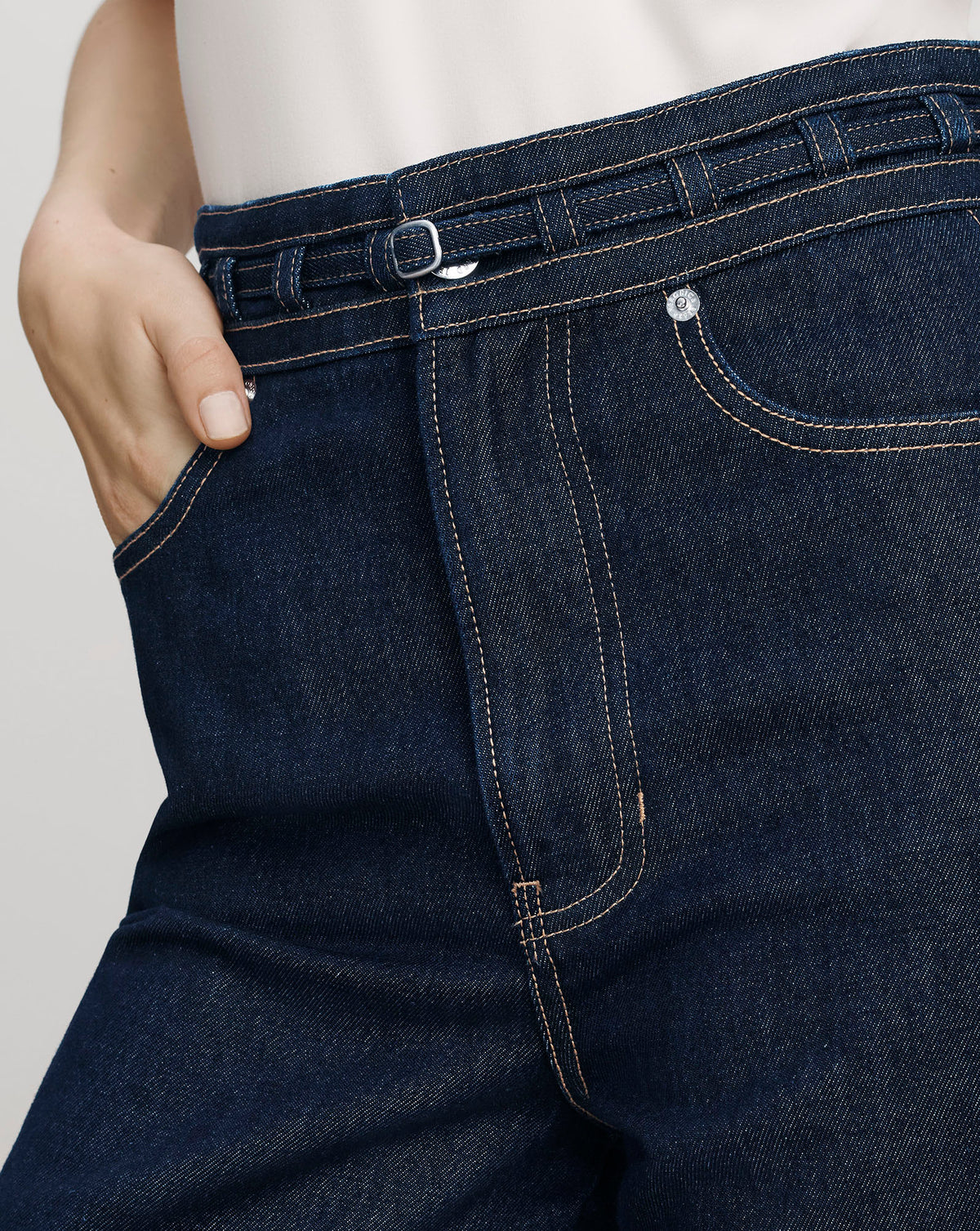 Veronica Beard Dark blue denim high-waisted belted jeans.