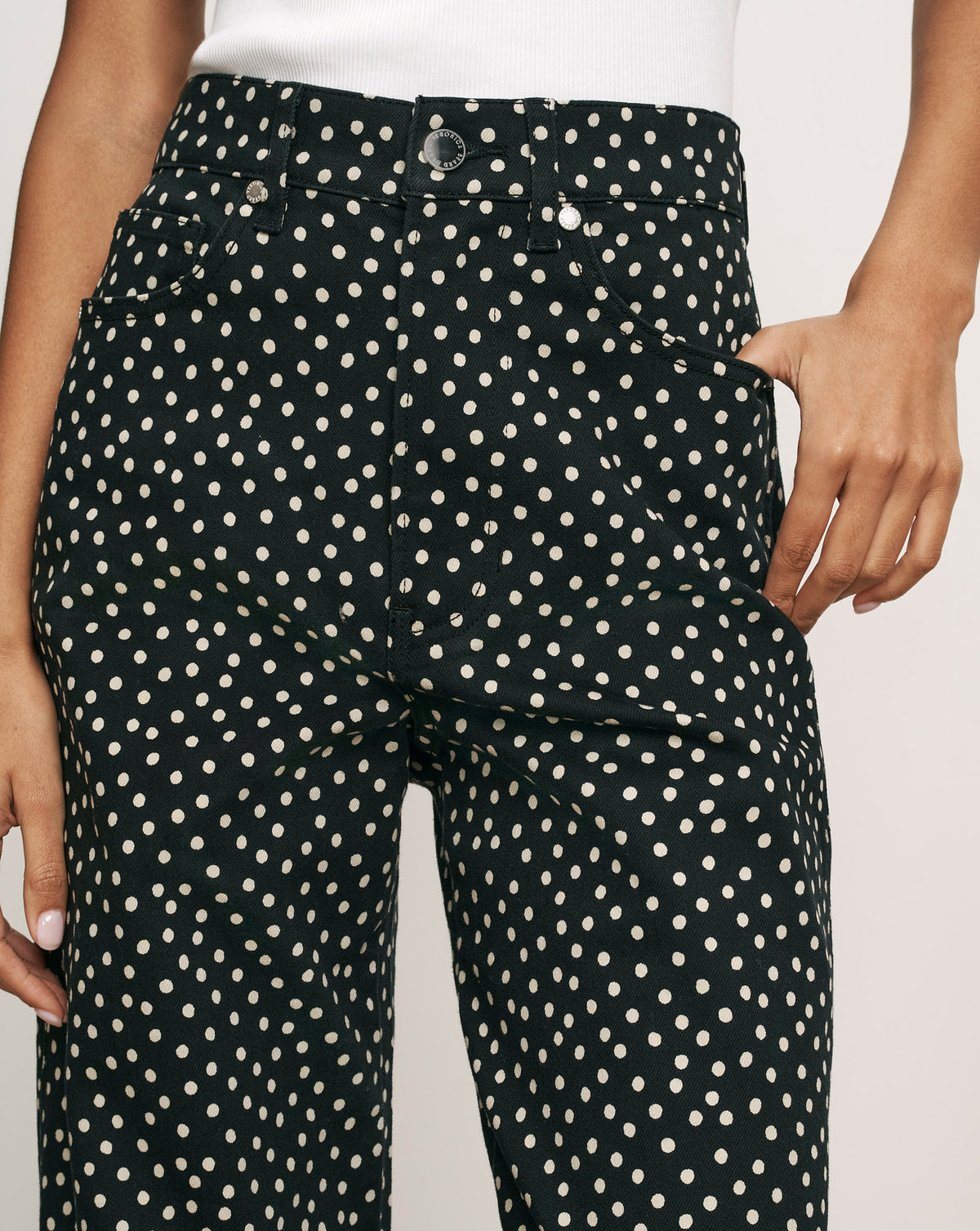 Veronica Beard Black polka dot high-waisted denim pants.