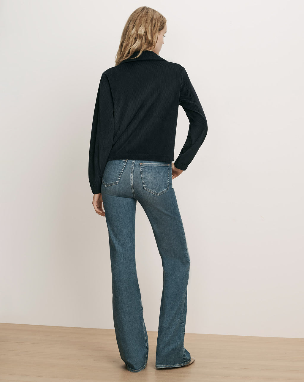 Veronica Beard Black corduroy jacket and blue denim jeans.