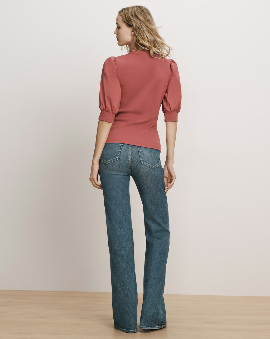Veronica Beard Pink puff-sleeve top and blue denim jeans.