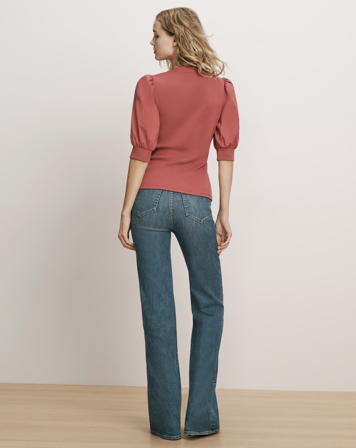 Veronica Beard Pink puff-sleeve top and blue denim jeans.
