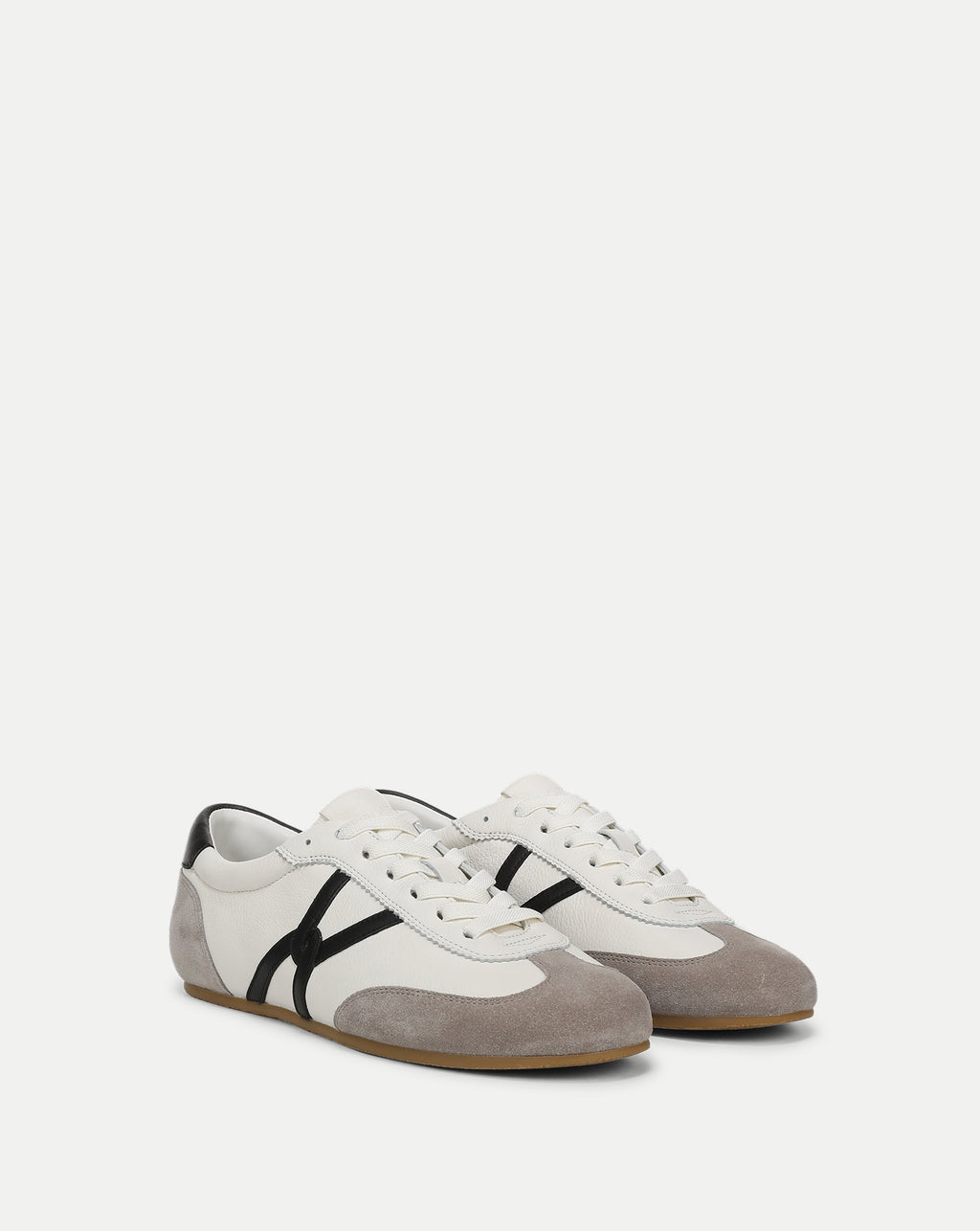 Veronica Beard White, black, and grey low-top sneakers.
