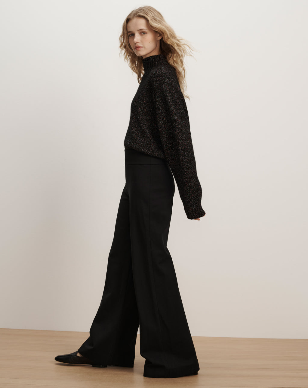 Veronica Beard Black sparkly turtleneck and wide-leg trousers.