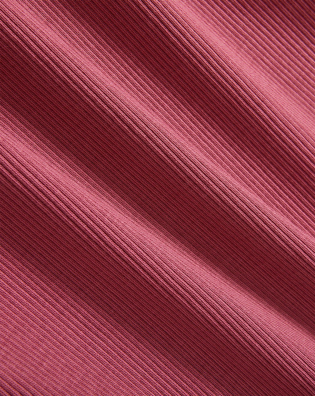 Veronica Beard Pink ribbed knit fabric with diagonal folds.