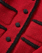 Veronica Beard Red tweed jacket with black fringe trim and buttons.