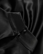 Veronica Beard Black silk blouse with covered button cuffs.
