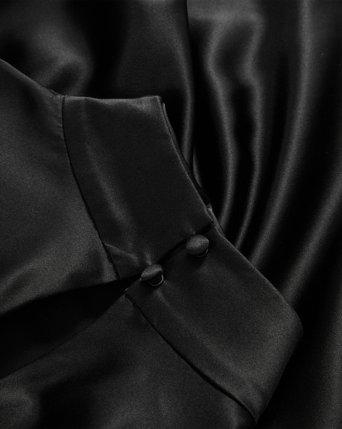 Veronica Beard Black silk blouse with covered button cuffs.