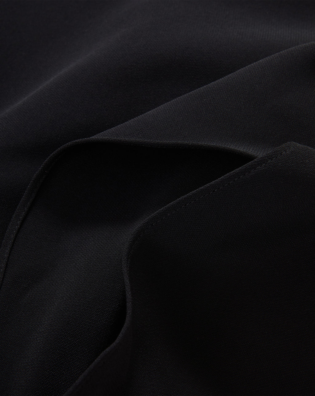Veronica Beard Black textured fabric garment with stitched seams.