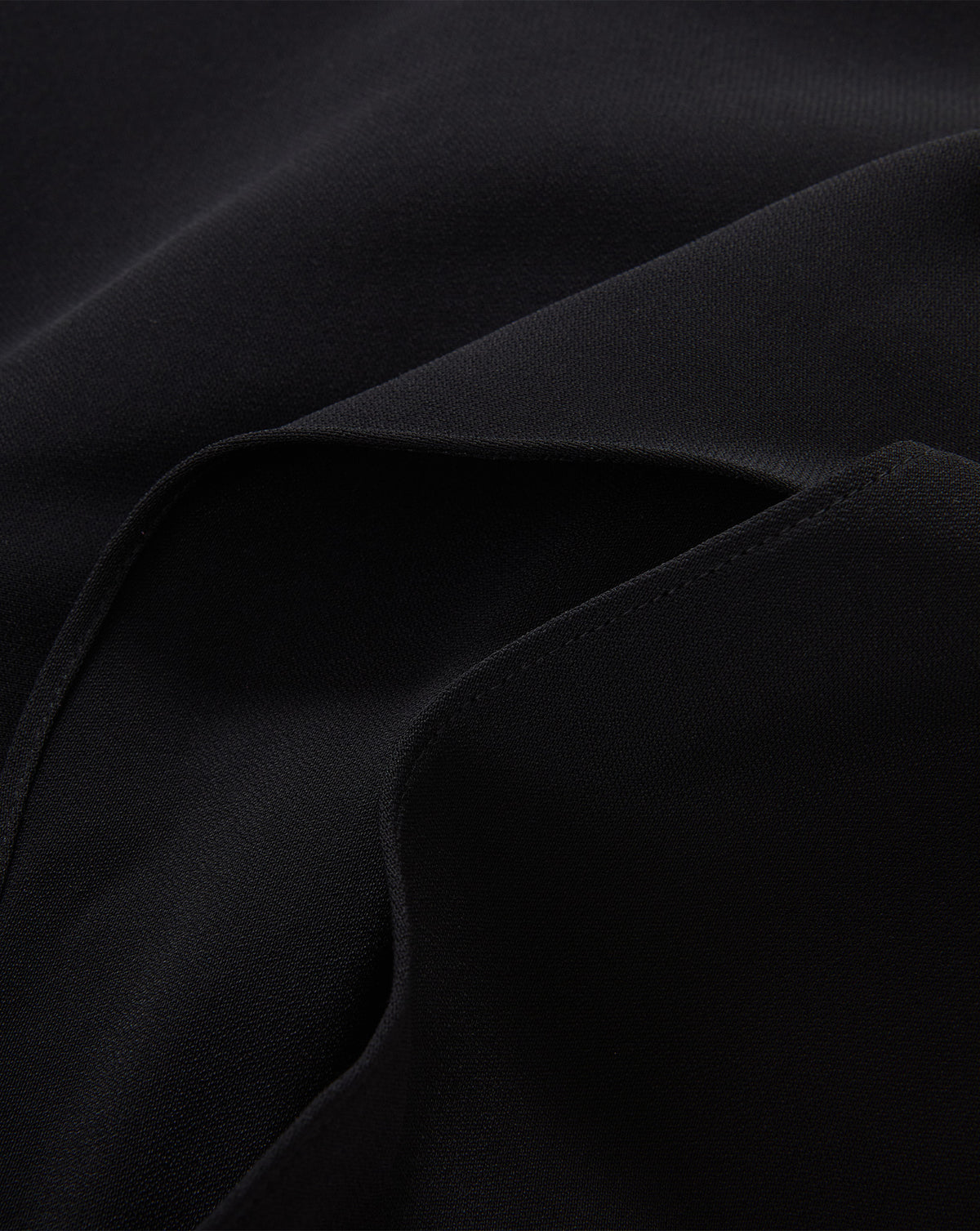Veronica Beard Black textured fabric garment with stitched seams.