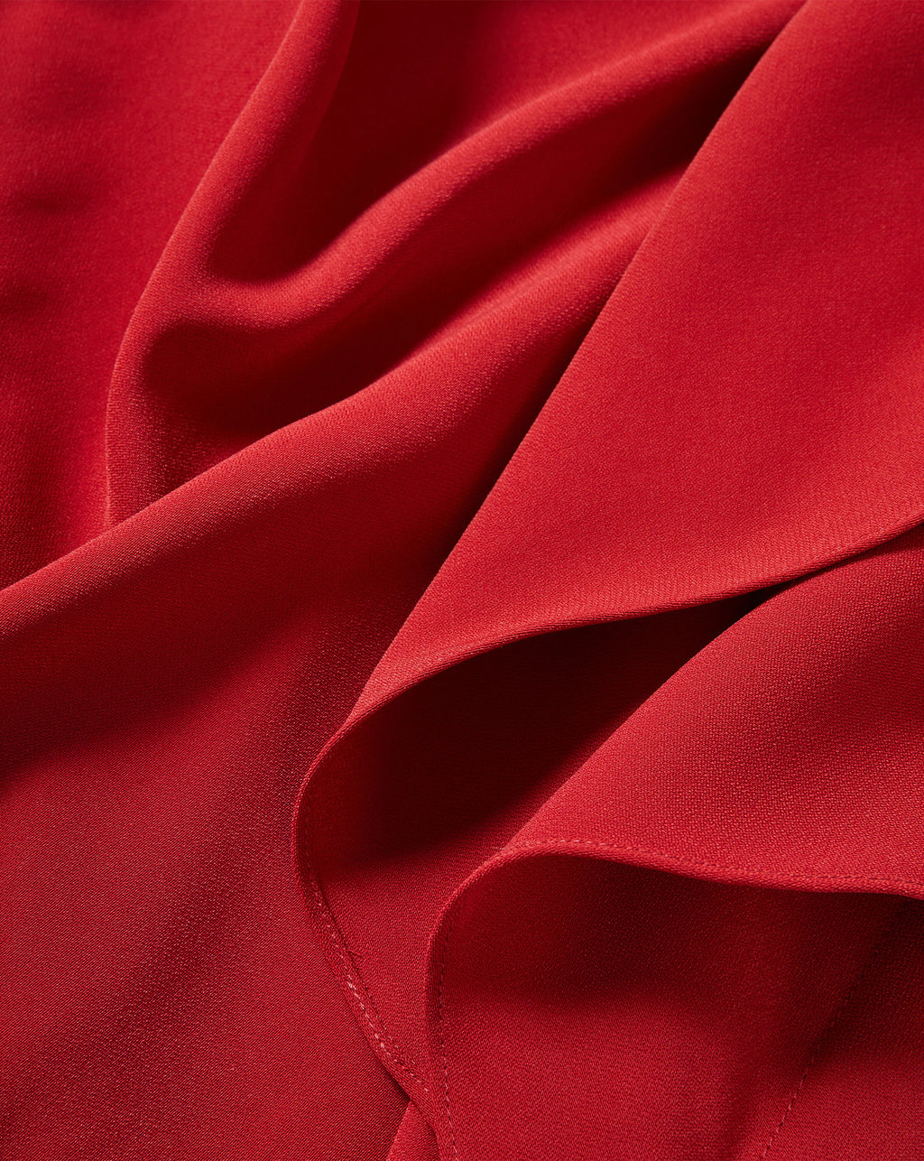 Veronica Beard Red woven fabric with draped silhouette and texture.