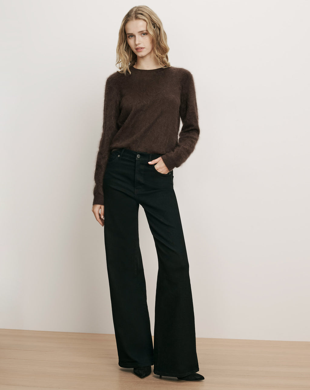 Veronica Beard Brown fuzzy sweater and black wide-leg jeans.