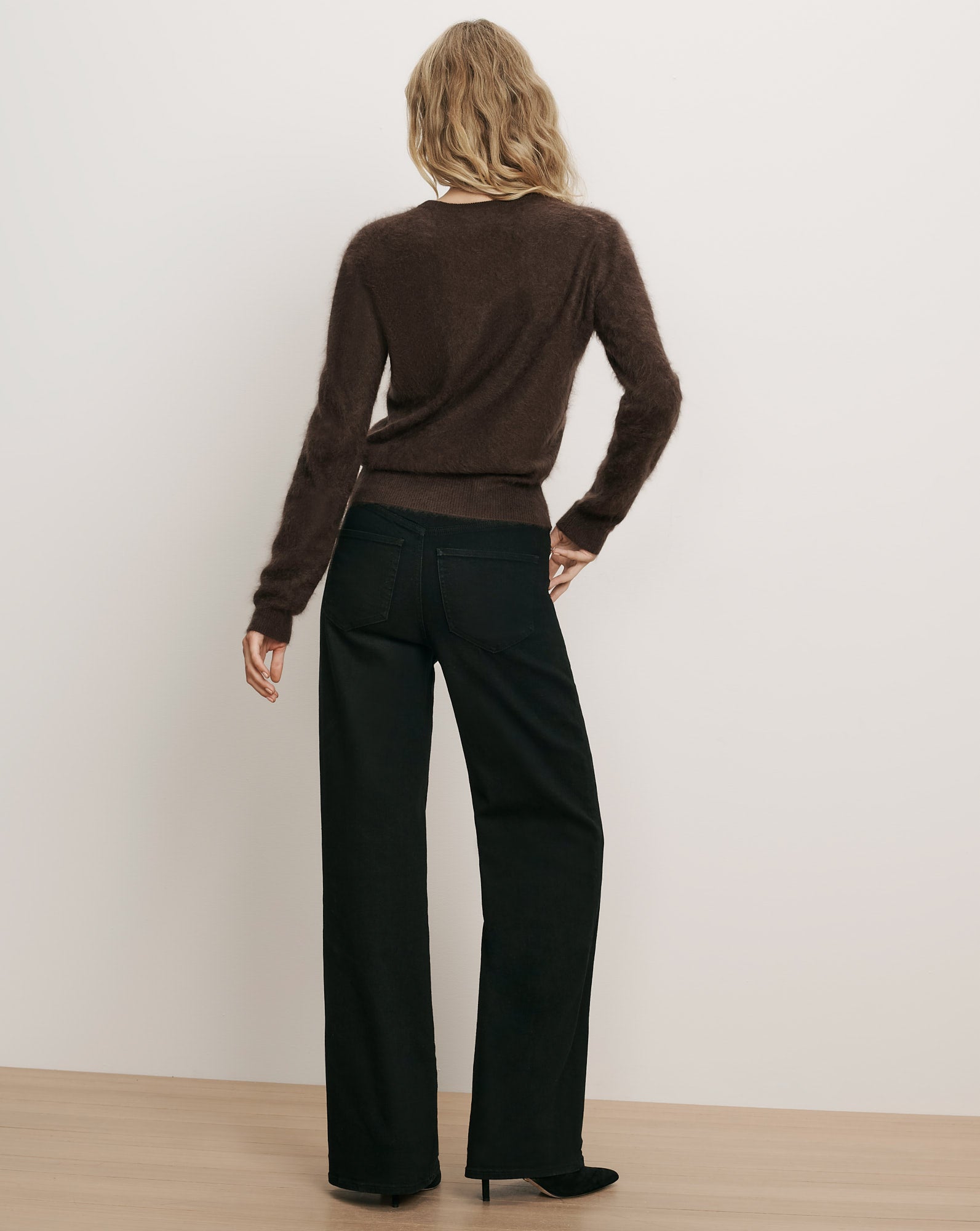 Veronica Beard Brown fuzzy sweater and black wide-leg jeans.