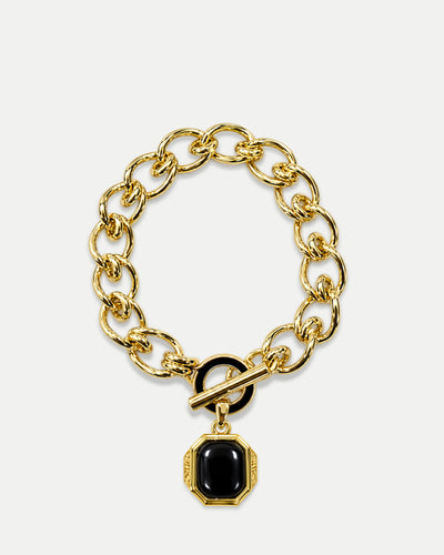 Veronica Beard Gold chain bracelet with black gemstone pendant.