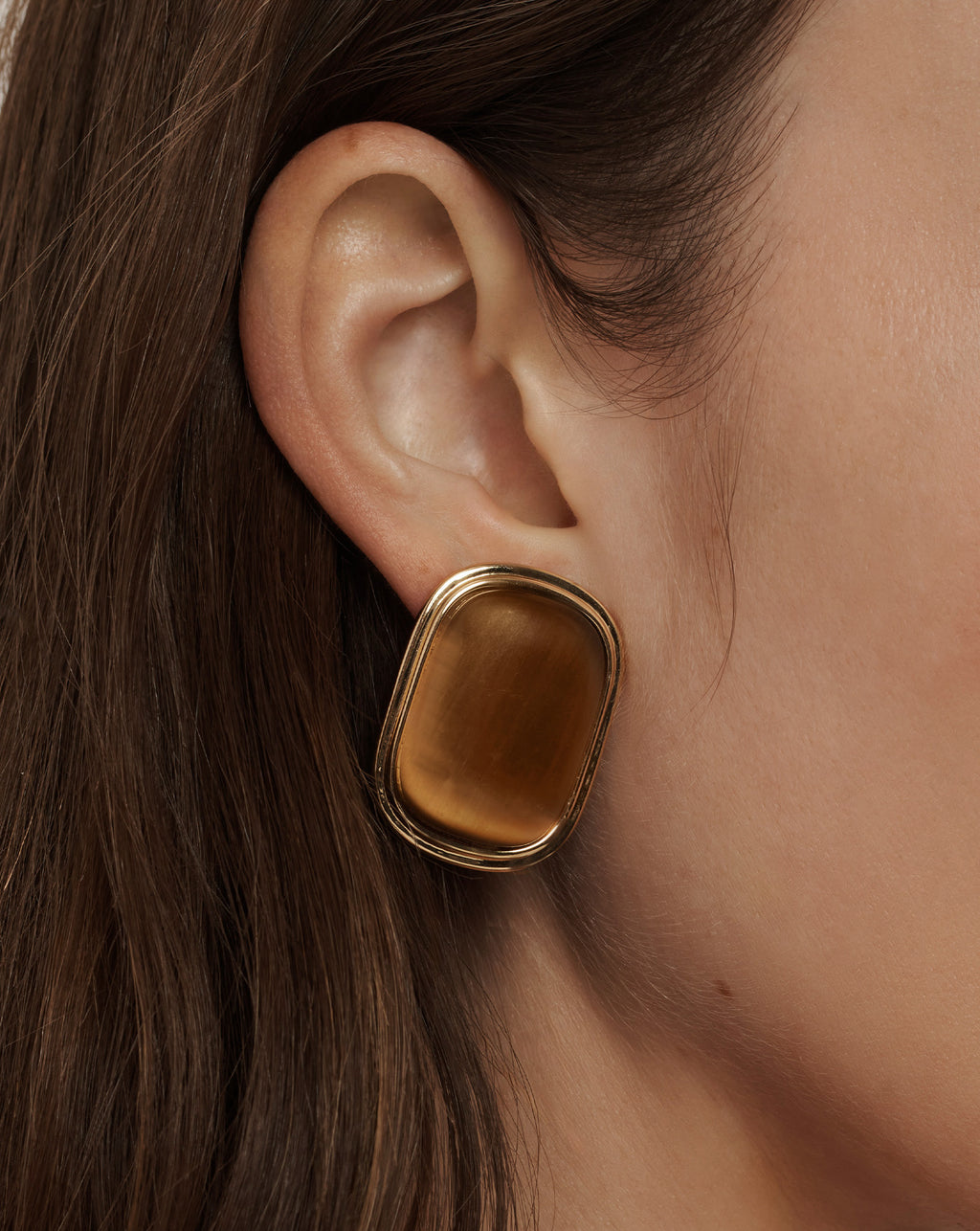 Veronica Beard Gold-framed rectangular earrings with a smooth, amber-colored stone.