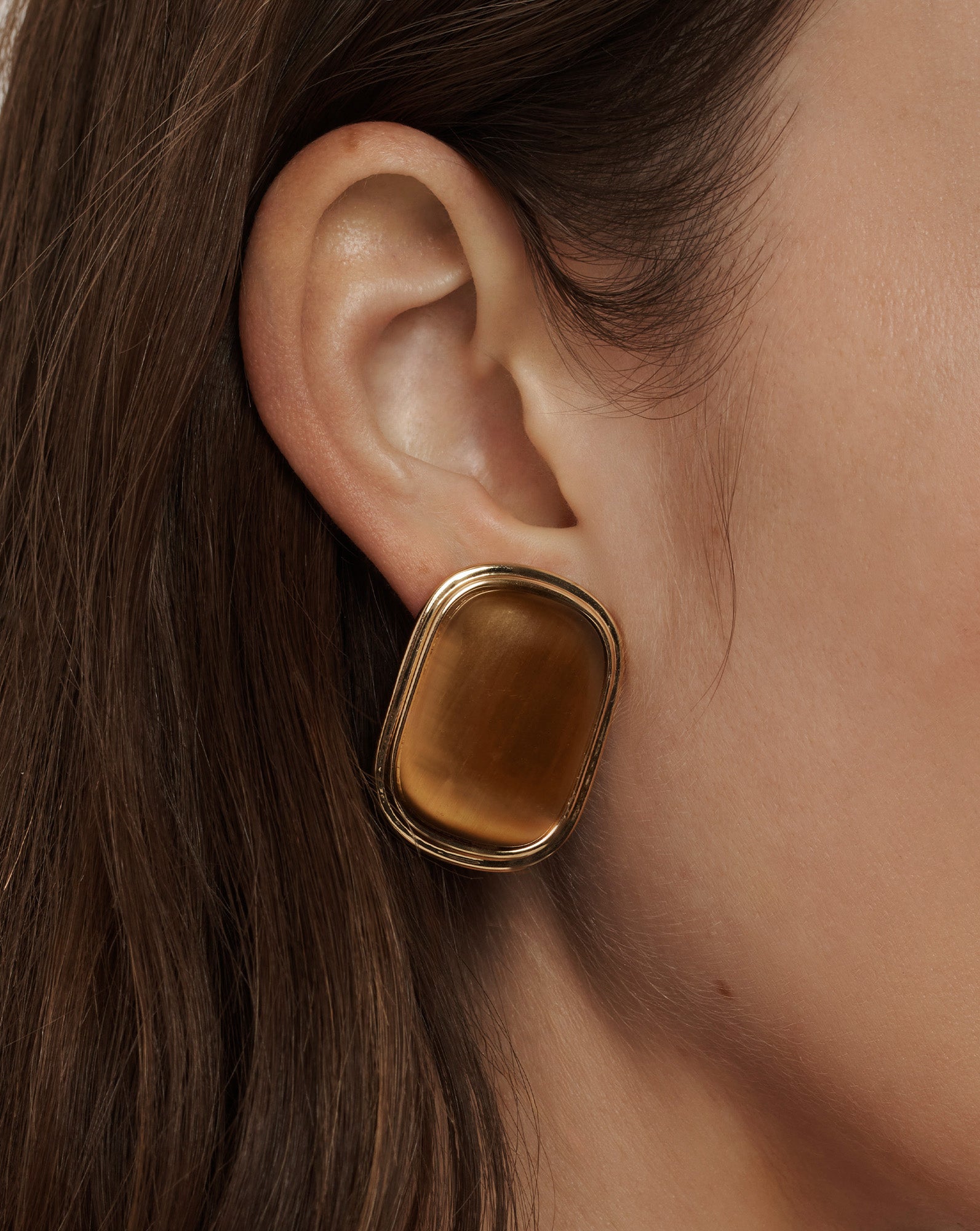 Veronica Beard Gold-framed rectangular earrings with a smooth, amber-colored stone.