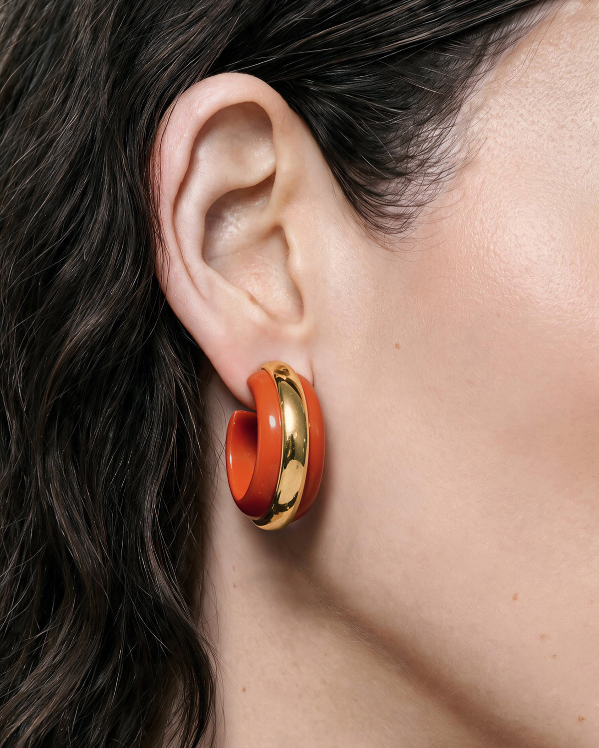 Veronica Beard Chunky orange and gold hoop earrings.