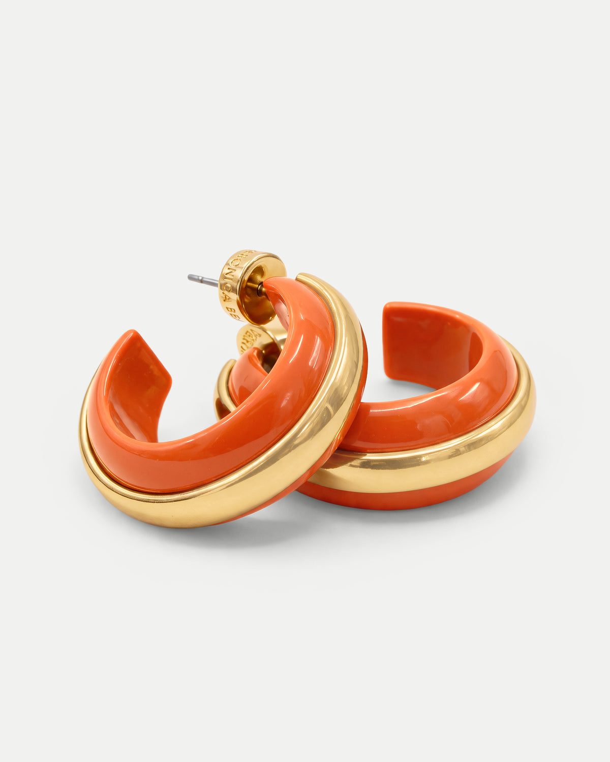 Veronica Beard Orange and gold chunky hoop earrings.