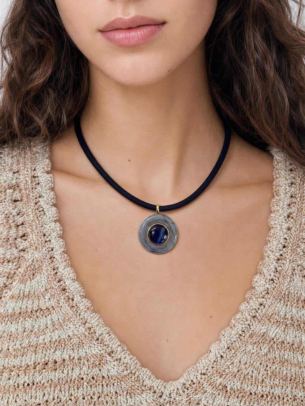Veronica Beard Black cord necklace with round gray and blue pendant.