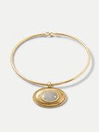 Veronica Beard Gold choker necklace with oval mother-of-pearl pendant.