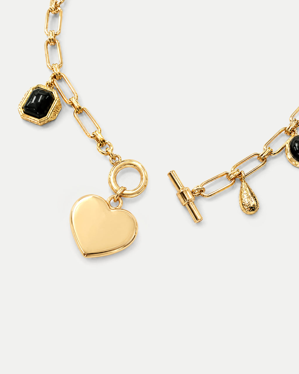 Veronica Beard Gold chain necklace with charms and toggle clasp.