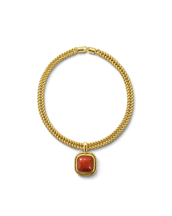 Veronica Beard Gold chain necklace with a red gemstone pendant.