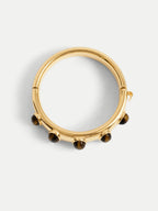 Veronica Beard Gold hinged bangle bracelet with round stones.