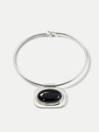 Veronica Beard Silver choker necklace with large black oval pendant.