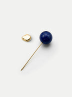 Veronica Beard Gold lapel pin with blue lapis lazuli sphere.