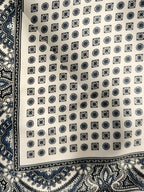 Veronica Beard White silk scarf with blue geometric and paisley patterns.