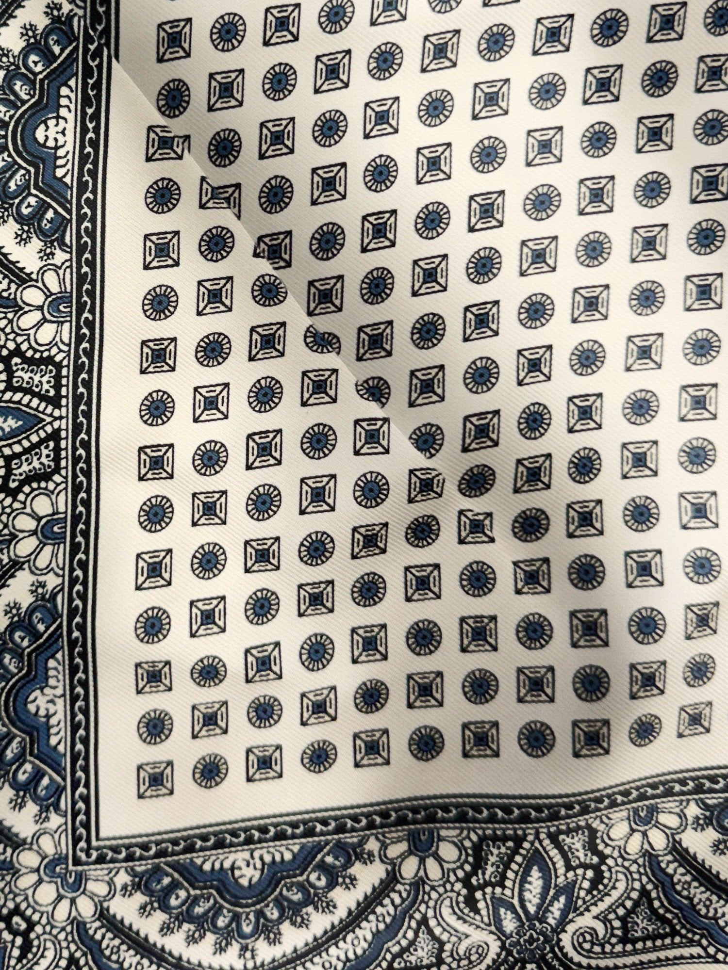 Veronica Beard White silk scarf with blue geometric and paisley patterns.
