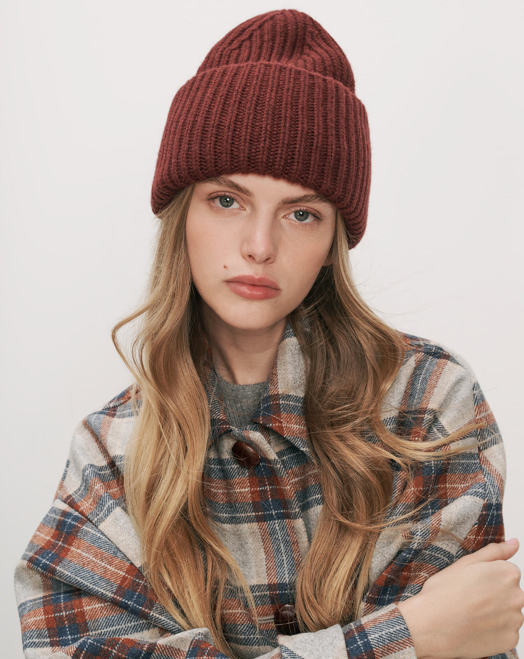 Veronica Beard Red knit beanie and plaid flannel jacket.