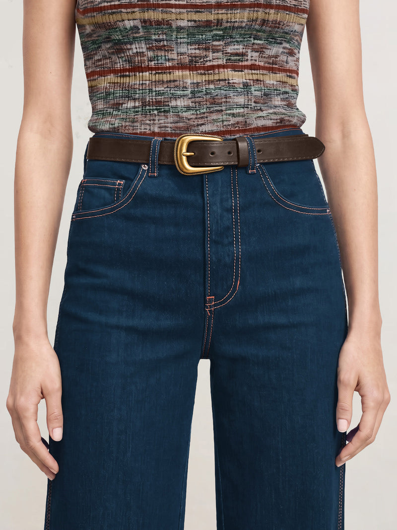Veronica Beard Dark blue jeans, brown leather belt, multicolored knit top.
