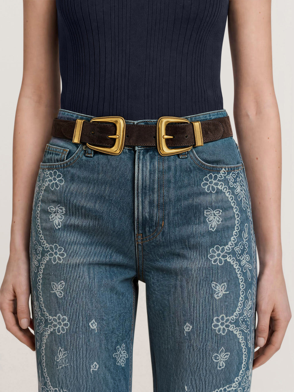 Veronica Beard Blue embroidered jeans with a brown double-buckle belt.
