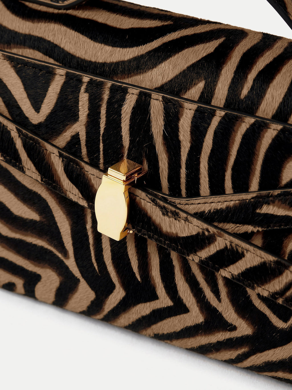Veronica Beard Brown and black zebra print handbag with gold clasp.