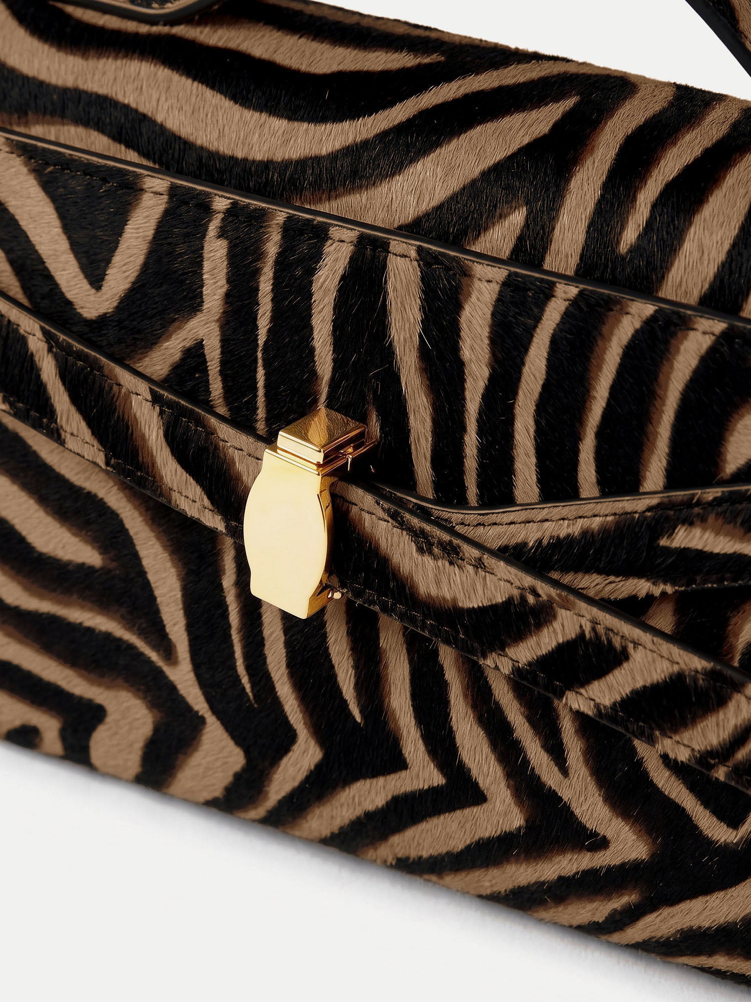 Veronica Beard Brown and black zebra print handbag with gold clasp.