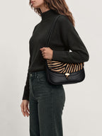 Veronica Beard Black turtleneck sweater and dark jeans.
