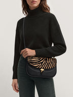 Veronica Beard Black and tan zebra-print leather crossbody bag.