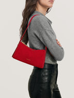 Veronica Beard Gray knit sweater and black leather pants.