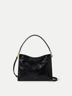 Veronica Beard Black patent leather shoulder bag with gold hardware.