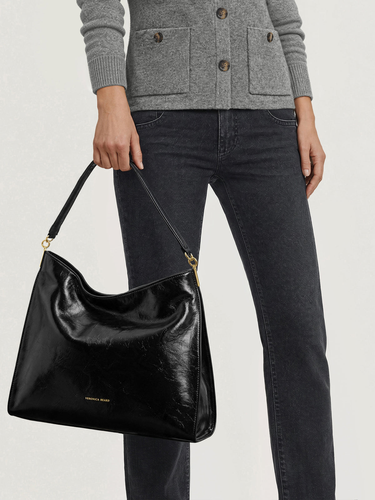 Veronica Beard Black leather slouchy shoulder bag with gold hardware.