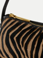 Veronica Beard Zebra print calf hair shoulder bag with gold zipper.