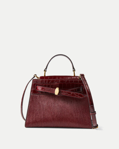 Veronica Beard Burgundy faux-crocodile leather handbag with gold clasp.