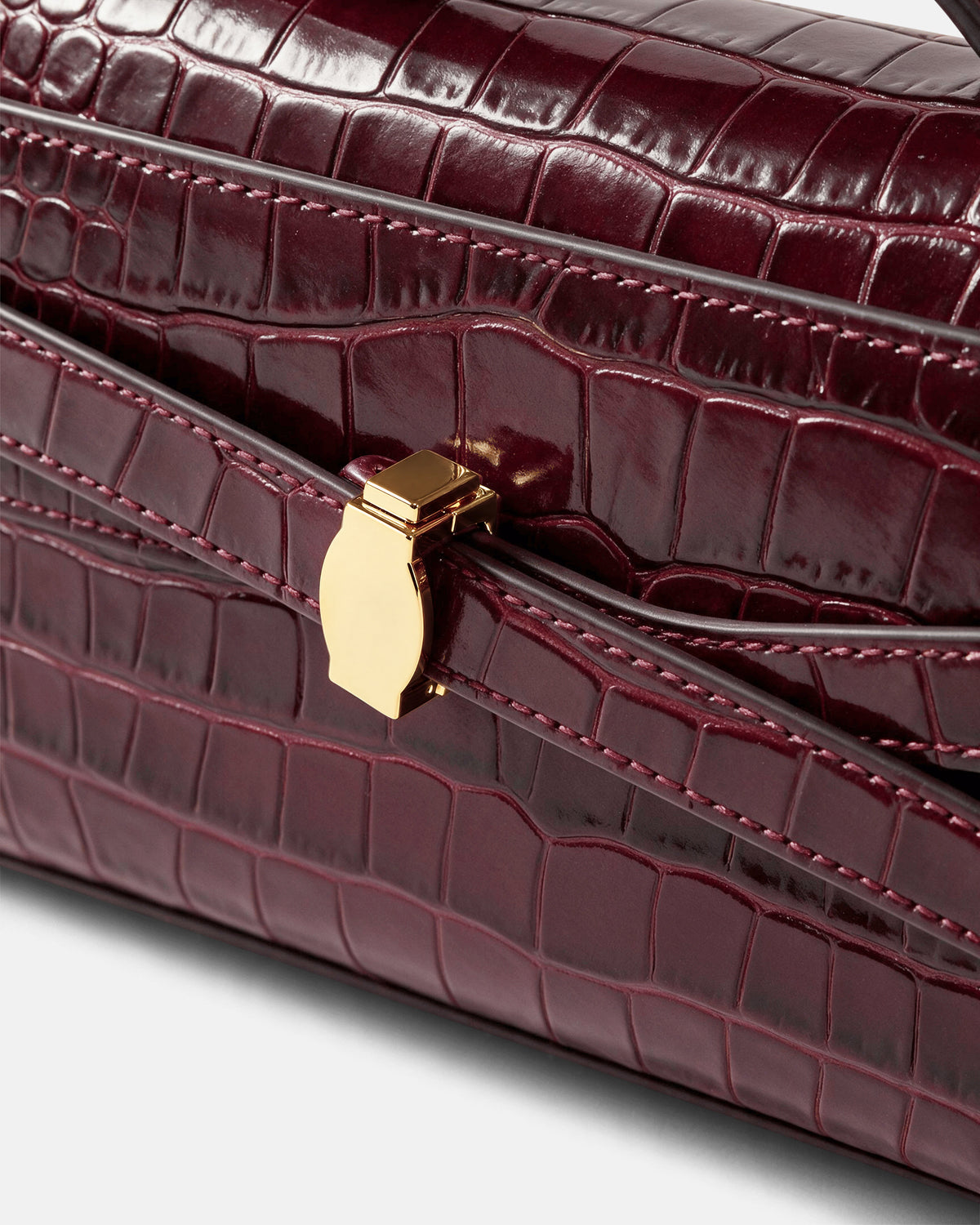 Veronica Beard Burgundy embossed leather handbag with gold clasp.