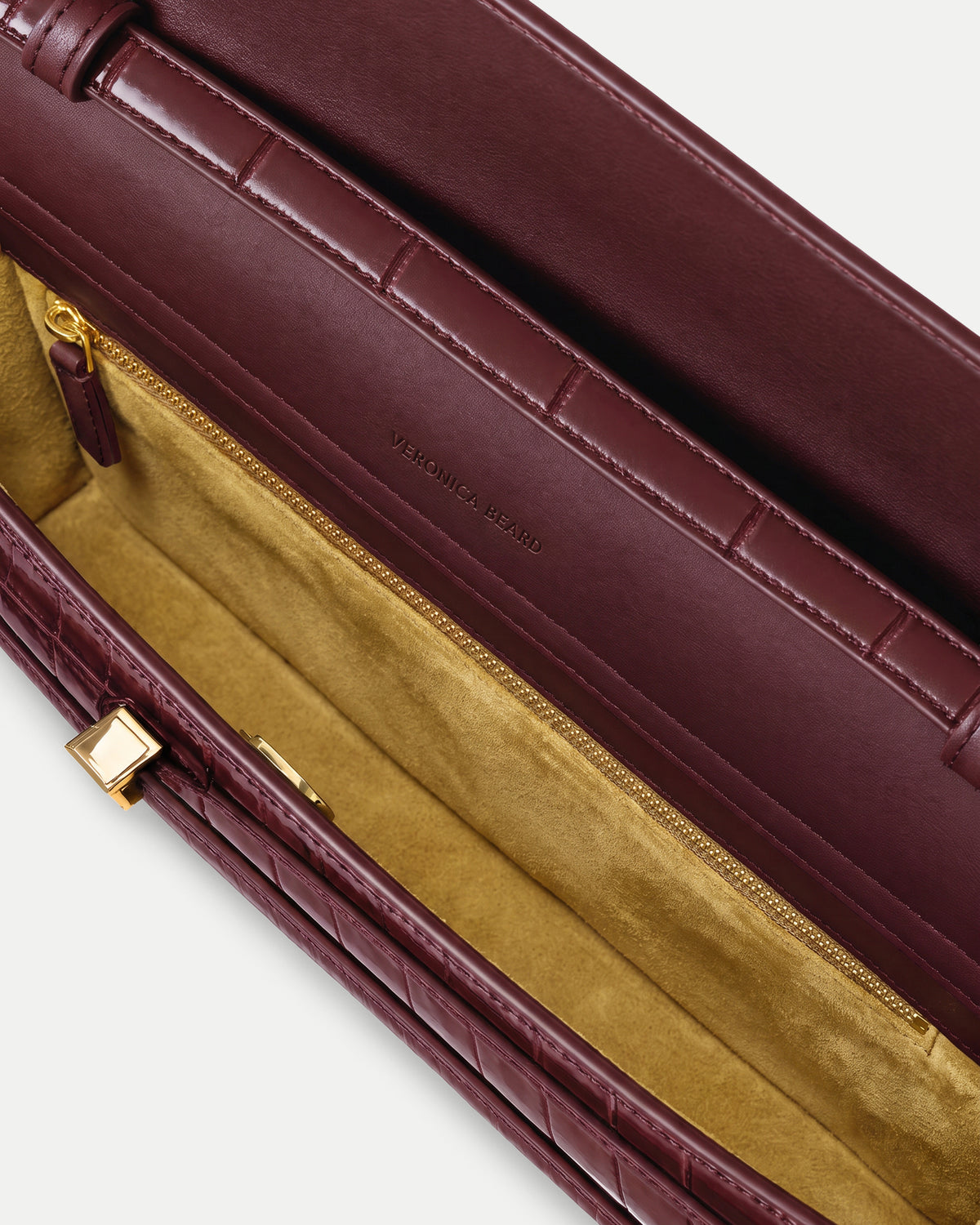 Veronica Beard Burgundy quilted leather structured handbag with gold zipper.