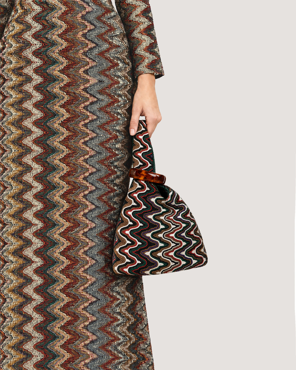 Veronica Beard Multicolor zig-zag knit dress and matching handbag.