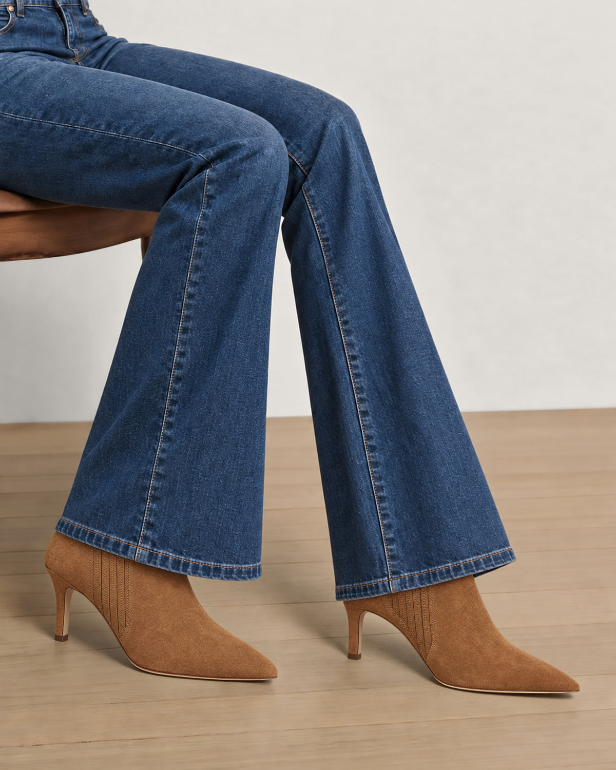 Veronica Beard Blue denim flare jeans and brown heeled boots.