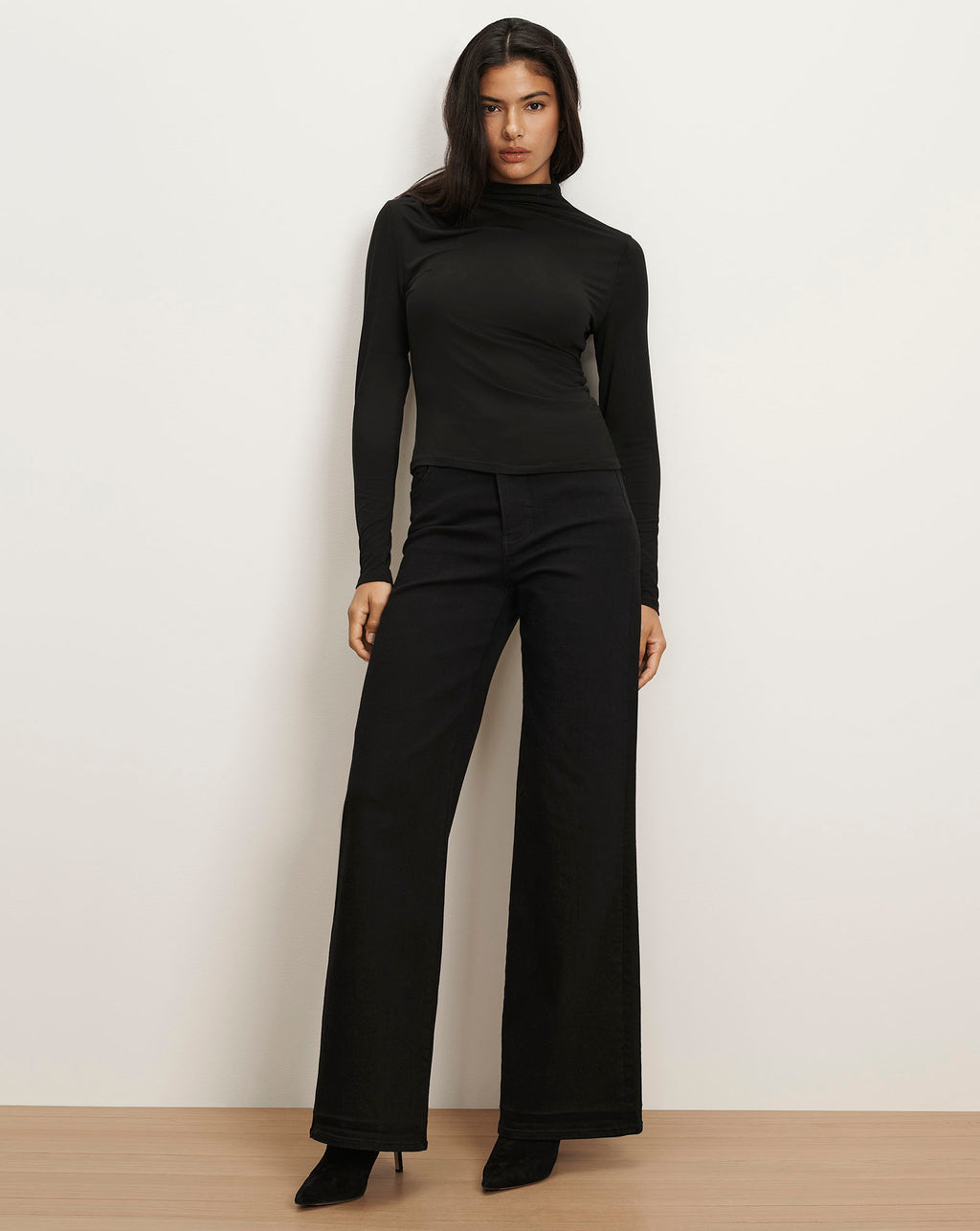 Veronica Beard Black long-sleeve turtleneck top and wide-leg pants.