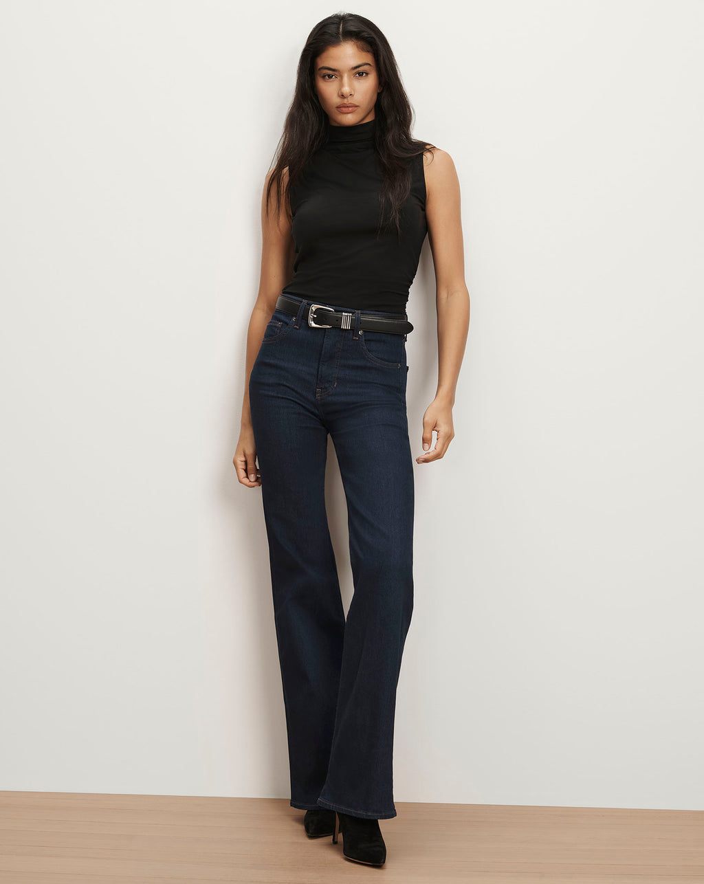 Veronica Beard Black sleeveless turtleneck, dark wash flare jeans.